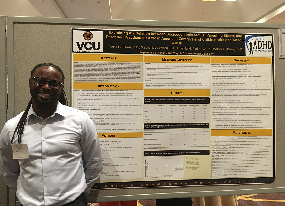 Alfonso Floyd at the 2017 XULA Diversity Conference in front of a research poster titled 
